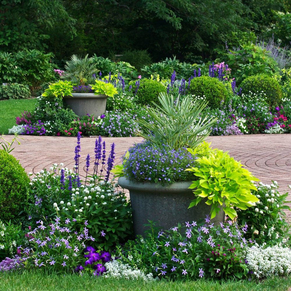 A path in a beautiful natural landscaped flower garden.